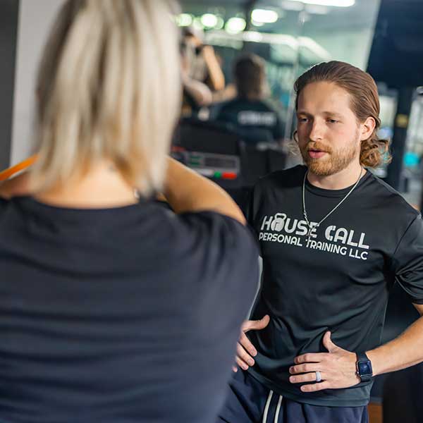 trainer-in-gym-with-woman-working-out-1